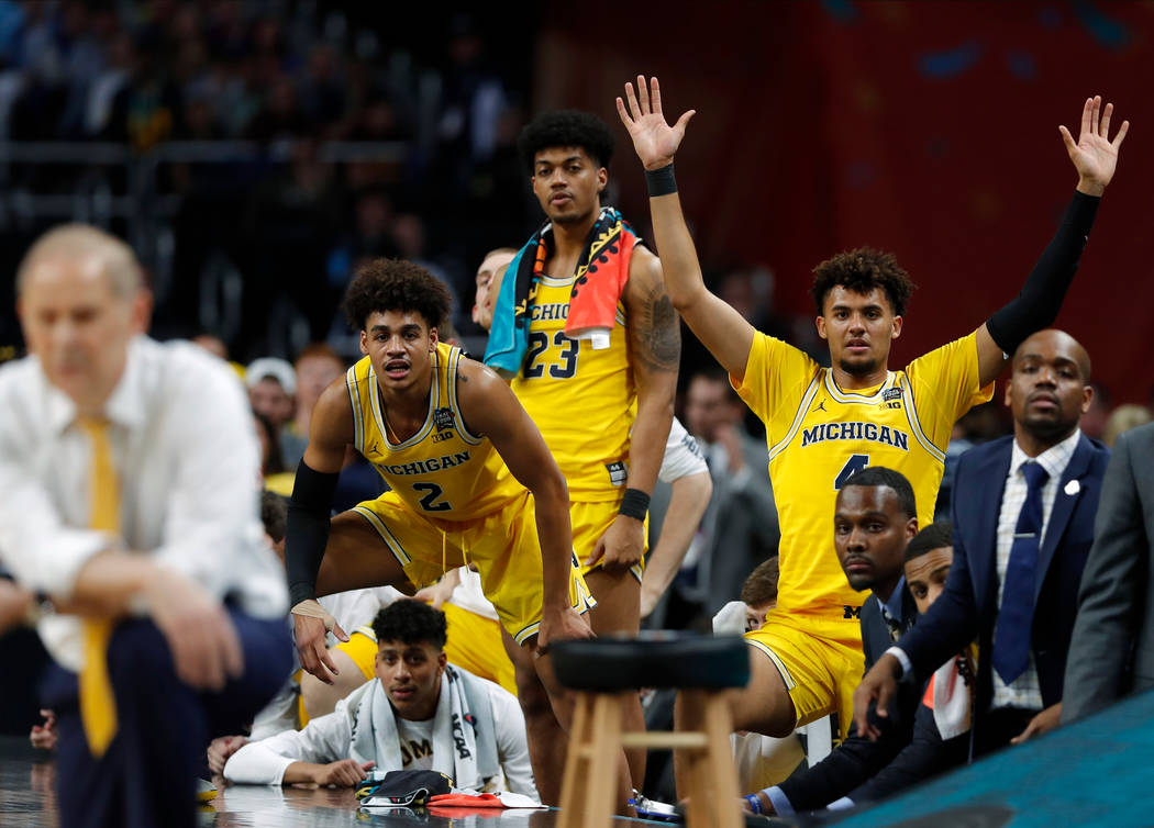 Michigan players on the bench watch during the second half in the semifinals of the Final Four NCAA college basketball tournament against Loyola-Chicago, Saturday, March 31, 2018, in San Antonio.  ...