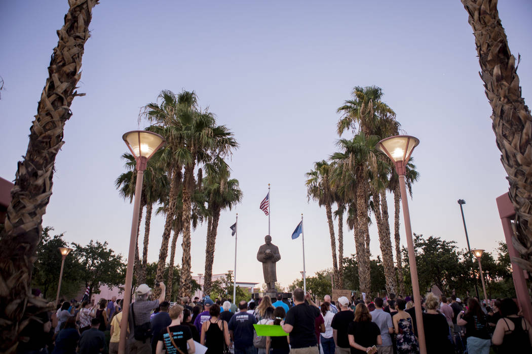 People attend a vigil at the Martin Luther King Jr. statue in North Las Vegas on Aug. 13, 2017. (Elizabeth Brumley/Las Vegas Review-Journal)