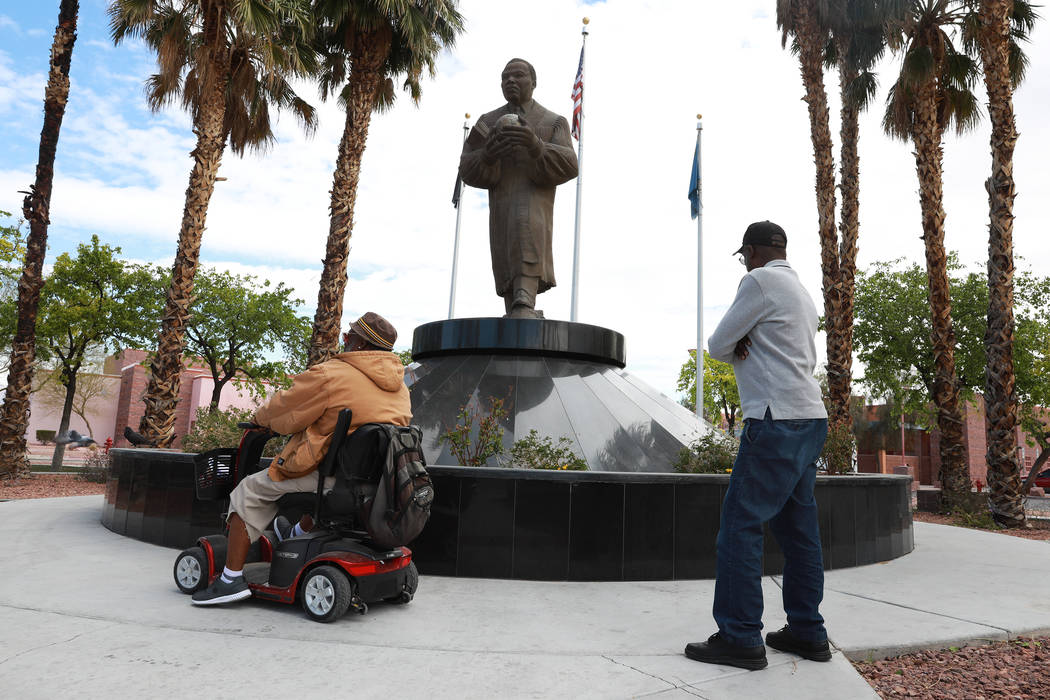 Walter "Mista" Kinchen, left, and Eddie Ashley look at the Martin Luther King Jr. statue near the intersection of Martin Luther King Boulevard and Carey Avenue in North Las Vegas on Wednesday, Mar ...