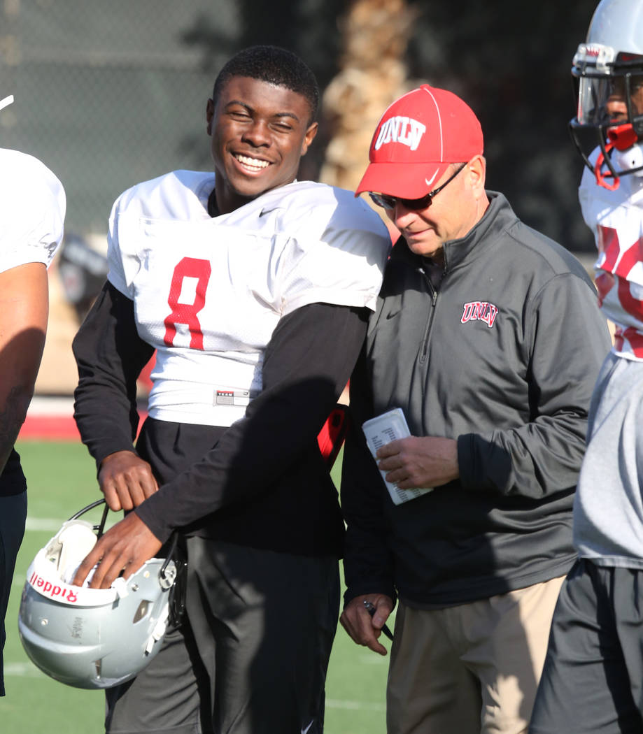 UNLV running back Charles Williams (8) chats with UNLV's Director of Athletic Training Kyle Wilson during a team practice on Tuesday, April 3, 2018, in Las Vegas. Bizuayehu Tesfaye/Las Vegas Revie ...
