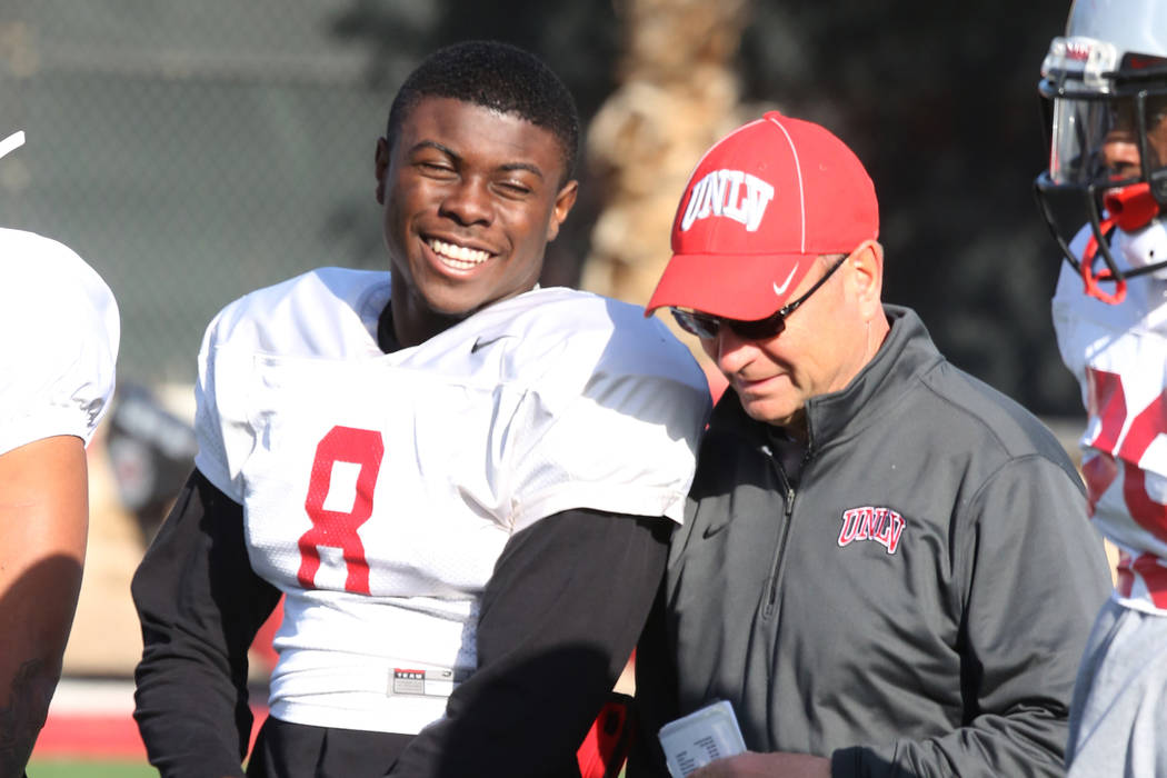 UNLV running back Charles Williams (8) chats with UNLV's Director of Athletic Training, Kyle Wilson, during team practice on Tuesday, April 3, 2018, in Las Vegas. Bizuayehu Tesfaye/Las Vegas Revie ...