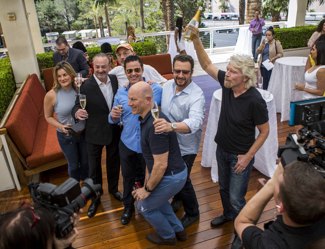 Virgin Group Founder Sir Richard Branson, right, Partner and Property CEO Richard ÒBozÓ Bosworth, second from left, and Virgin Hotels CEO Raul Leal, third from left, take a group photo with othe ...