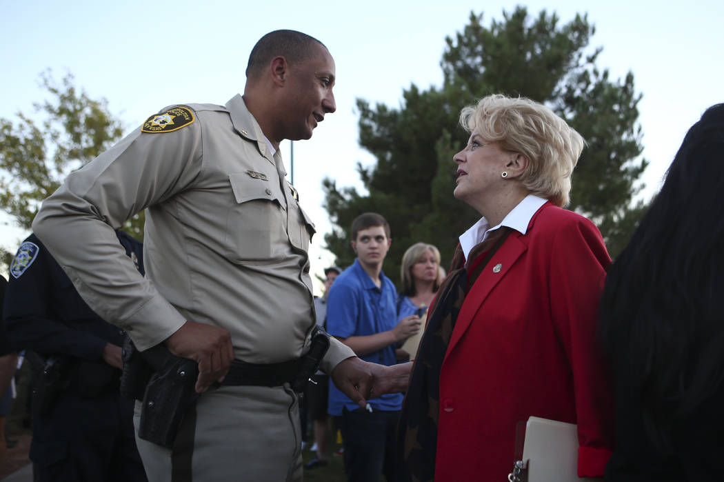 Deputy Chief Charles Hank, left, and Mayor Carolyn Goodman before the start of a candlelight vigil for Las Vegas police officer Charleston Hartfield, who was killed while off-duty in the Oct. 1 ma ...