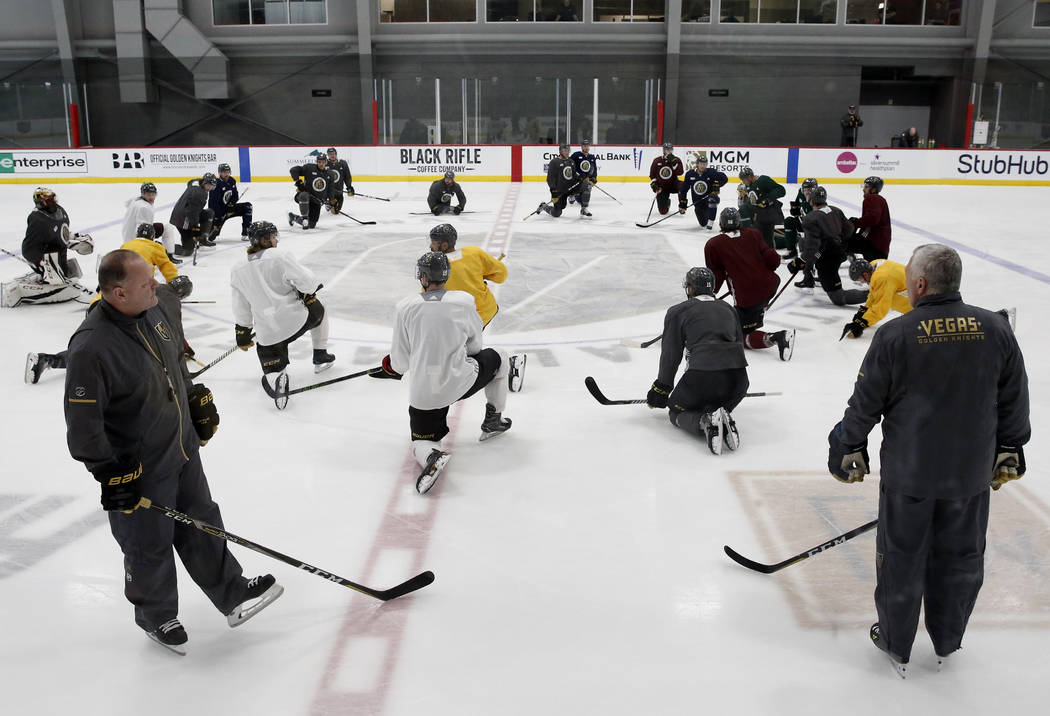 The Vegas Golden Knights head coach Gerald Gallant, left, and assistant coach Mike Kelly, watch as their players stretch during team practice on Monday, April 9, 2018, in Las Vegas. Bizuayehu Tesf ...
