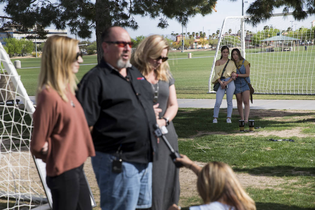 Ashlee Hawley, background right, sister of Brooke Hawley, a Centennial High School student killed in a car crash with a drunk driver in California, hugs friend Alana Maurer as her family speaks du ...