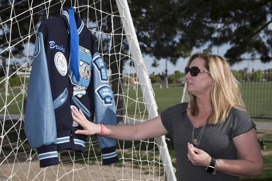 Rhonda Hawley touches the letterman jacket of her daughter Brooke, during a press conference announcing a memorial scholarship named after Brooke, at the Bettye Wilson Soccer Complex in Las Vegas, ...
