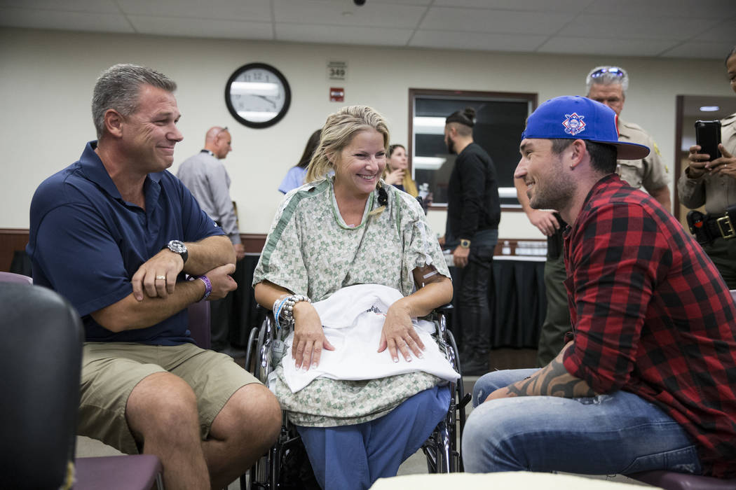Todd Kammer, from left, and his wife Lori of Orange County, Calif., speak with music artist Michael Ray at Sunrise Hospital following a music concert for patients and staff at the hospital auditor ...