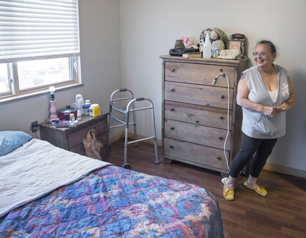 Army veteran Debbie Lara smiles as she reflects on her past struggles to find stable housing, while standing in her new one bedroom, furnished apartment on Tuesday, April 17, 2018, at Patriot Plac ...