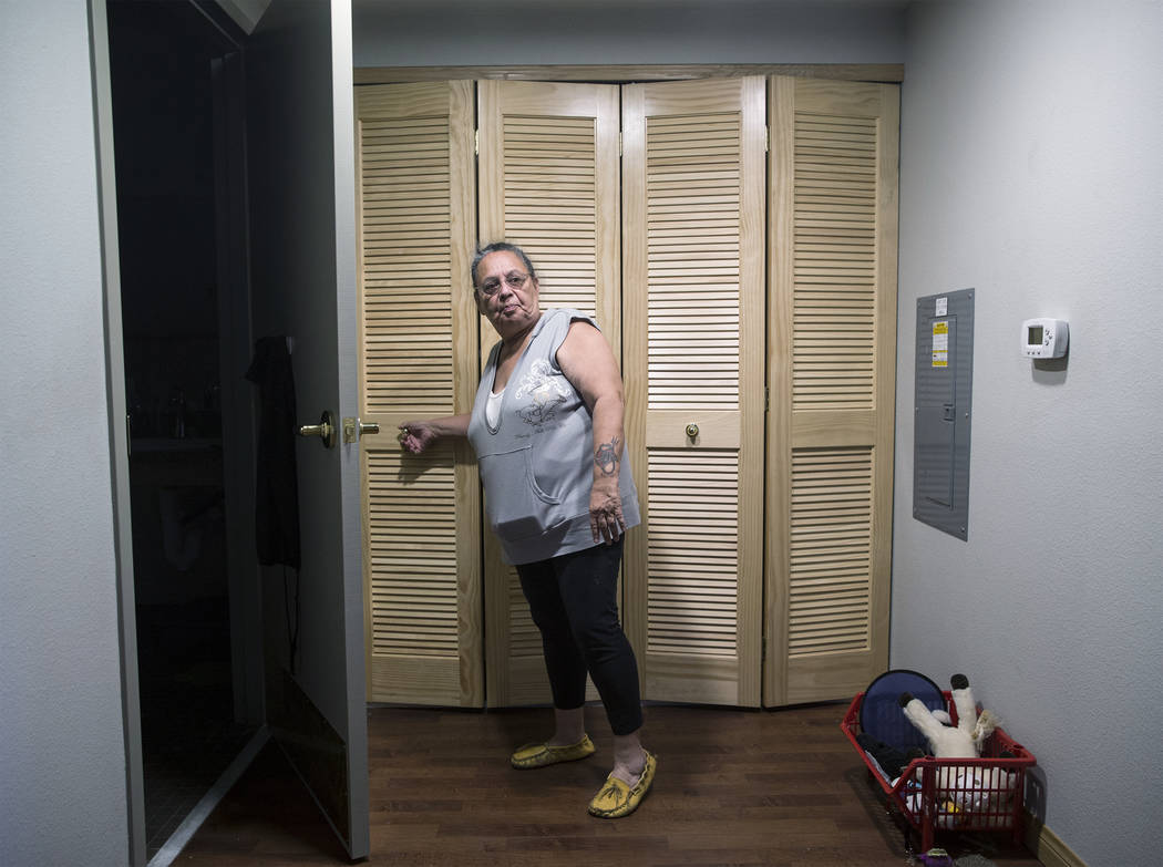 Army veteran Debbie Lara closes the laundry room door in her new one bedroom, furnished apartment on Tuesday, April 17, 2018, at Patriot Place Apartments, in Las Vegas. Patriot Place Apartments is ...