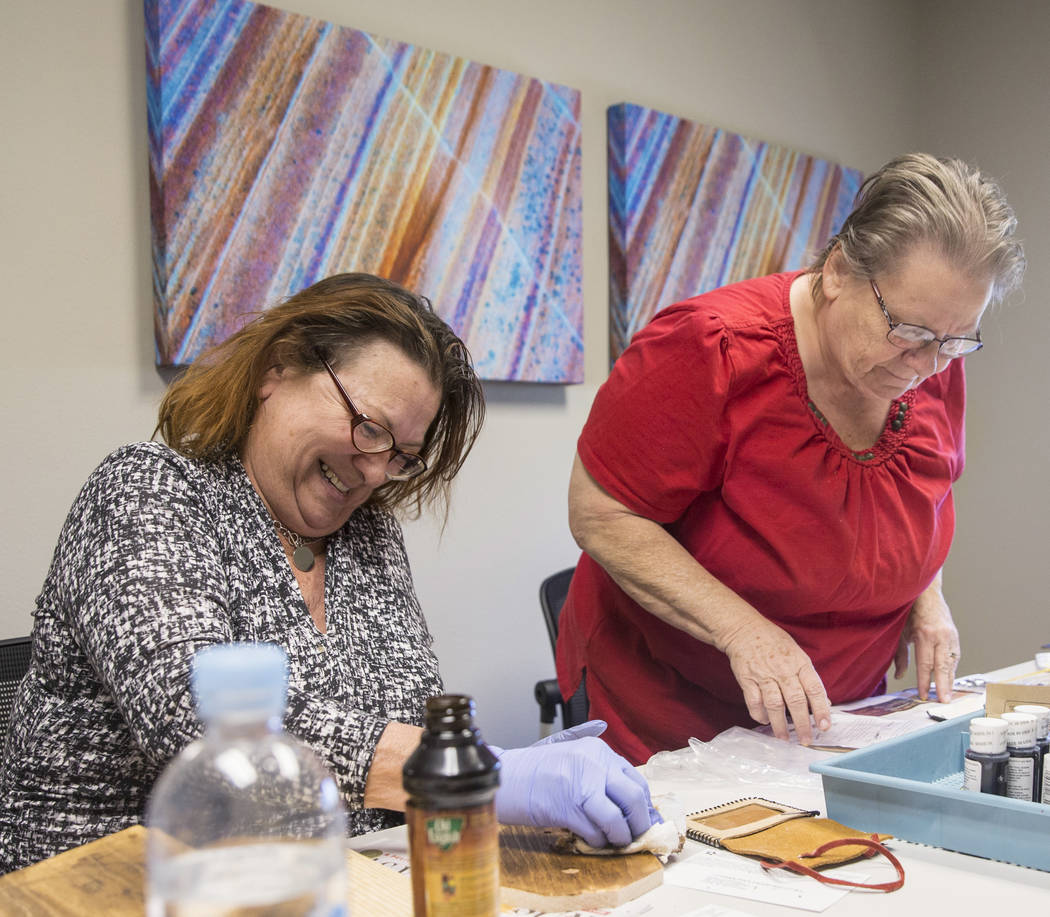 Clyda Byrd-Lopez, left, and Carol Ambrose build shoe shine boxes on Tuesday, April 17, 2018, at Patriot Place Apartments, in Las Vegas. Patriot Place Apartments is an affordable housing facility t ...