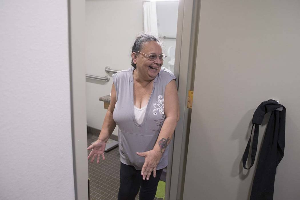 Army veteran Debbie Lara expresses her happiness with the size of her new bathroom in her one bedroom, furnished apartment on Tuesday, April 17, 2018, at Patriot Place Apartments, in Las Vegas. Pa ...