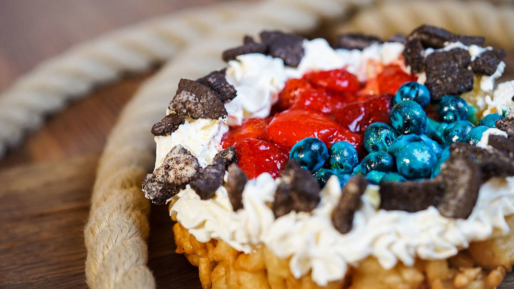 Favorite Pixar pals and stories are inspiring delicious treats, such as berry funnel cake at Golden Horseshoe, Disneyland park. (Disneyland Resort)