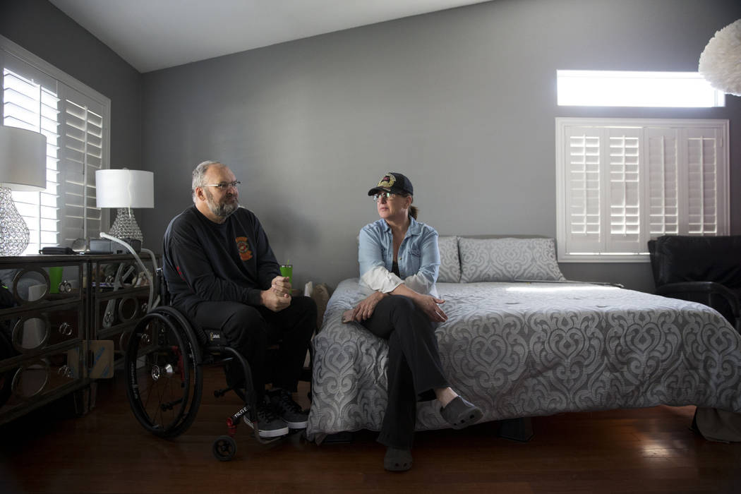 Military veteran Ed Wiesing with his wife Dana Wagner, at their Las Vegas home, Thursday, April 12, 2018. Wiesing underwent a surgical procedure last year that left him paralyzed from his legs. Th ...