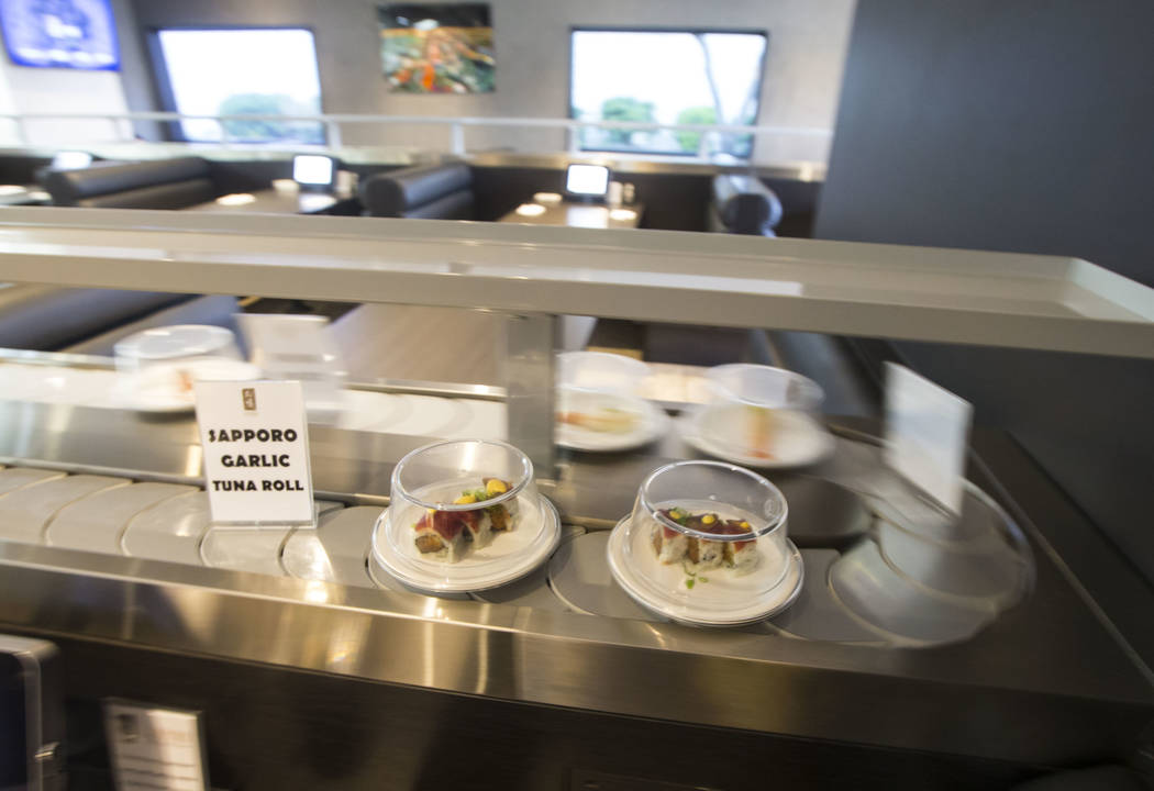 A Sapporo garlic tuna roll passes by on the conveyor belt at Sapporo Revolving Sushi in Las Vegas on Wednesday, April 25, 2018. Chase Stevens Las Vegas Review-Journal @csstevensphoto