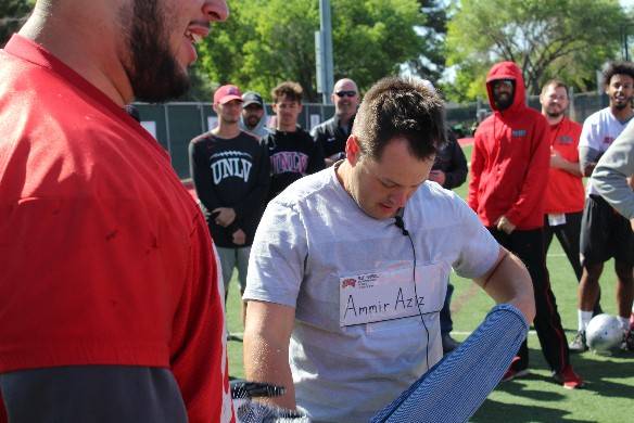 The envelope with UNLV senior defensive tackle Ammir Aziz's scholarship is taped to performer Farrell Dillon's chest. It was part of a ruse to inform Aziz of the news. Photo courtesy of UNLV Athle ...