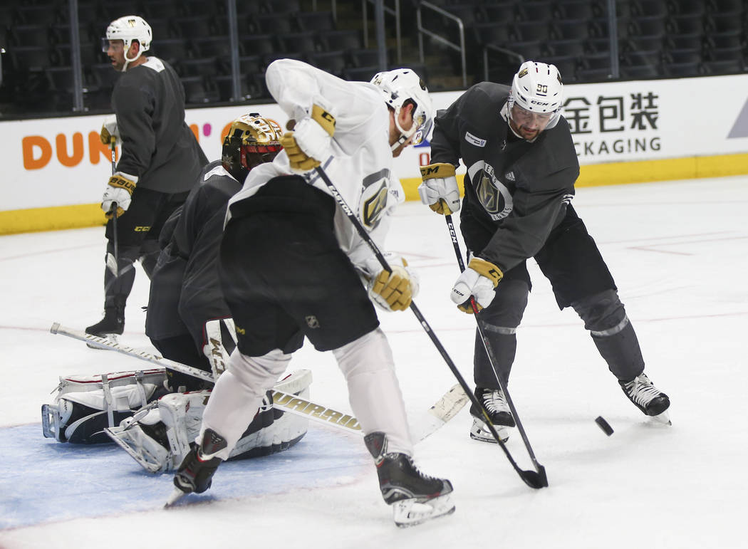 Golden Knights left wing Tomas Tatar, right, looks to shoot as Knights center Oscar Lindberg and goaltender Malcolm Subban defend during practice ahead of Game 4 against the Los Angeles Kings, sla ...