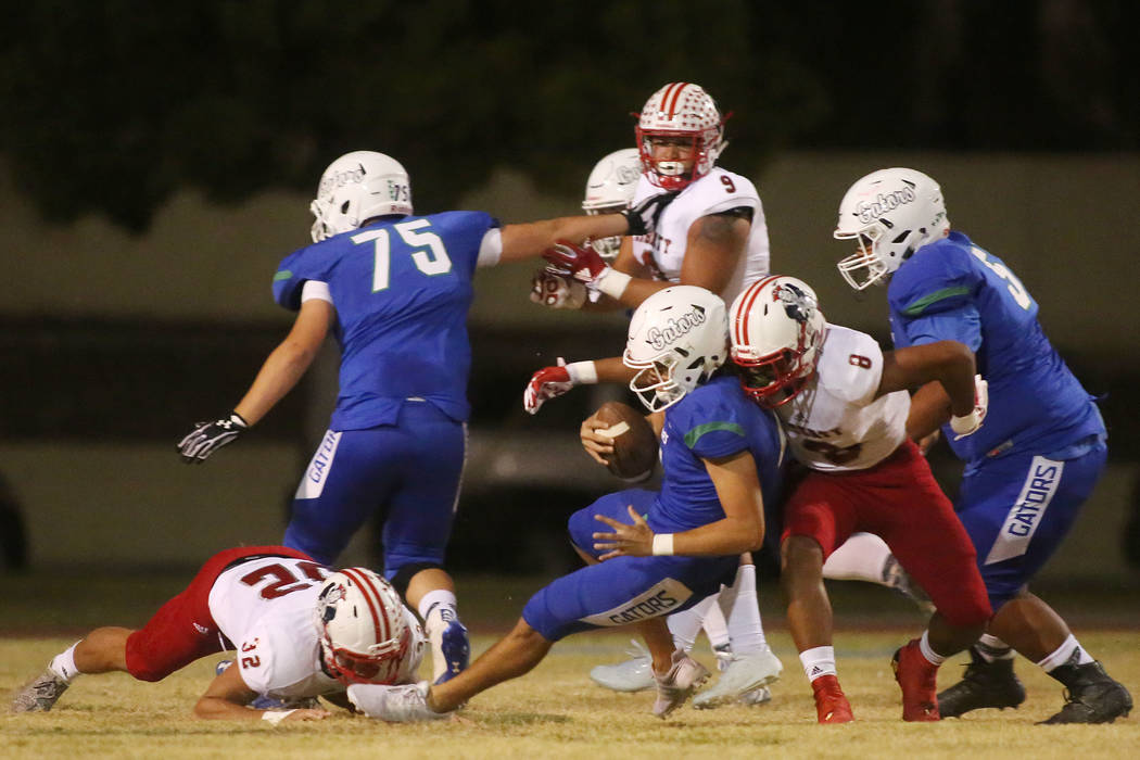 Liberty's Austin Fiaseu (8) takes down Green Valley quarterback A.J. Barilla during the first half of a game at Green Valley High School in Henderson, Thursday, Sept. 28, 2017. Bridget Bennett Las ...