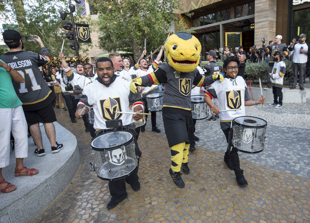 The Vegas Golden Knights mascot Chance the Golden Gila Monster and the Knight Line participates in the March to the Fortress ahead of Game 1 of an NHL hockey first-round playoff series between the ...
