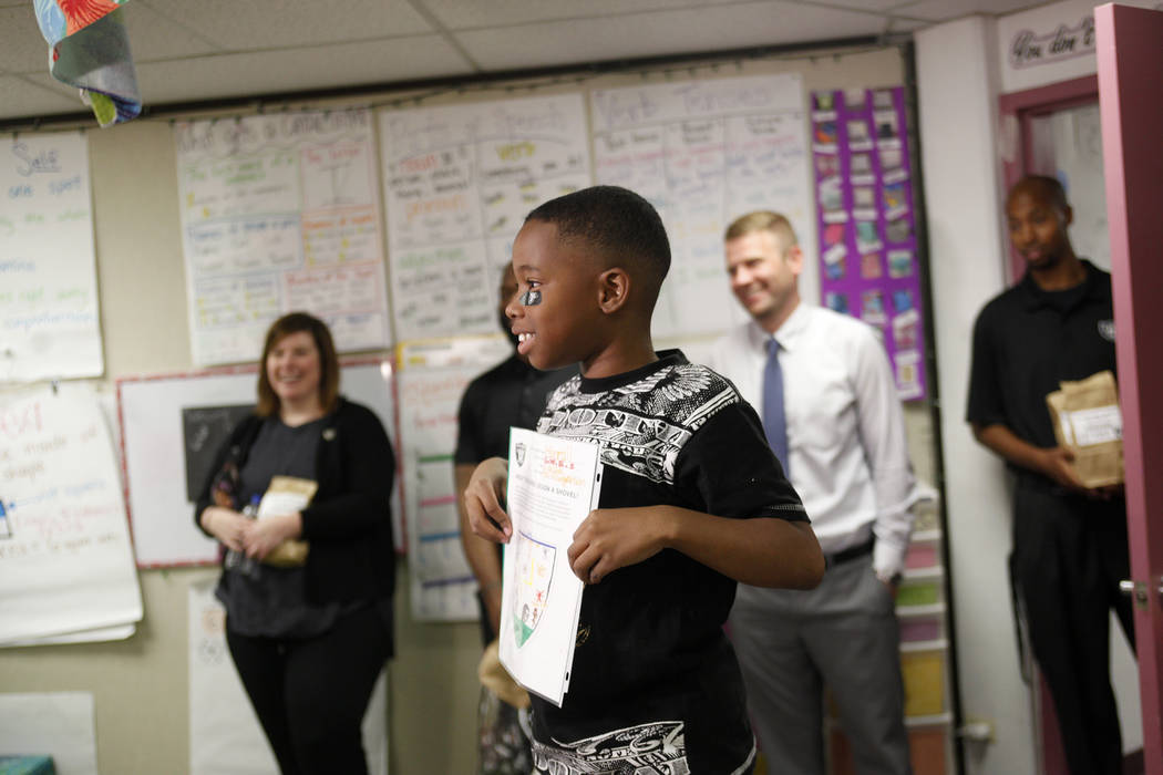 Marrail Parker-Briggs, 9, holds his drawing to show the Raiders players at Gene Ward elementary school in Las Vegas, Wednesday, May 9, 2018. Students participated in a raiders themed drawing conte ...