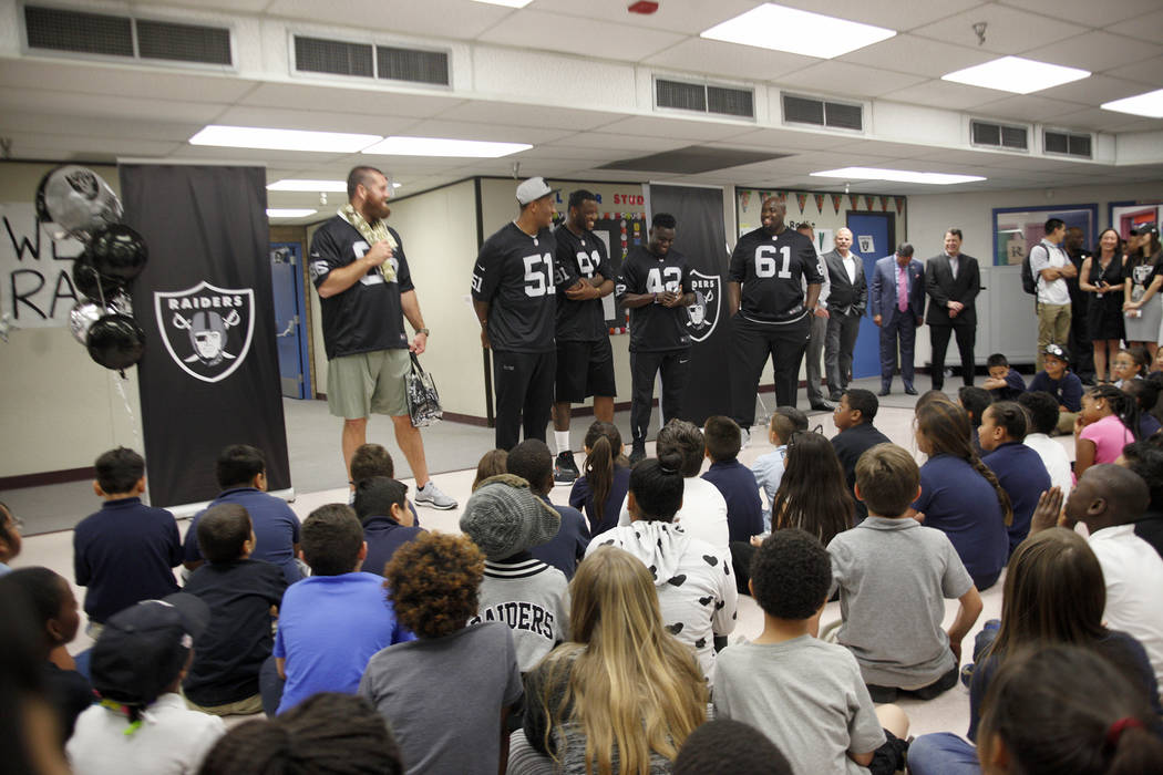 Oakland Raiders players Lee Smith, from left, Bruce Irvin, and Shilique Calhoun, Karl Joseph, and Rodney Hudson speak to students at Gene Ward elementary school in Las Vegas, Wednesday, May 9, 201 ...