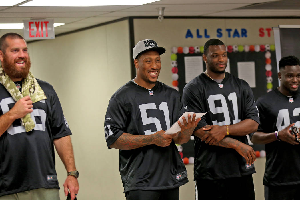 Oakland Raiders player Bruce Irvin announces the winner as fellow players Lee Smith, from left, Shilique Calhoun, and Karl Joseph stand by to speak to students at Gene Ward elementary school in La ...