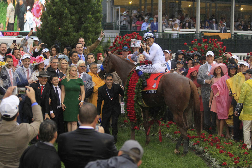 Mike Smith celebrates after riding Justify to victory during the 144th running of the Kentucky Derby horse race at Churchill Downs Saturday, May 5, 2018, in Louisville, Ky. (AP Photo/Garry Jones)