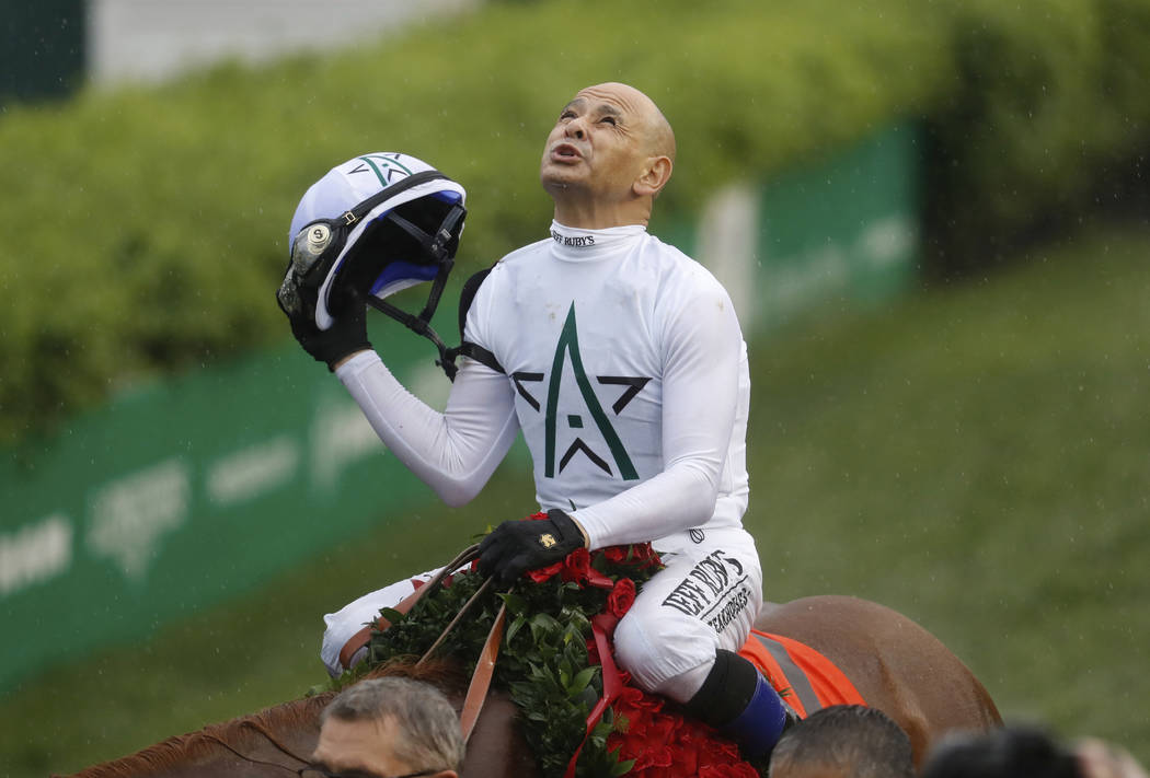 Mike Smith celebrates after riding Justify to victory during the 144th running of the Kentucky Derby horse race at Churchill Downs Saturday, May 5, 2018, in Louisville, Ky. (AP Photo/John Minchillo)