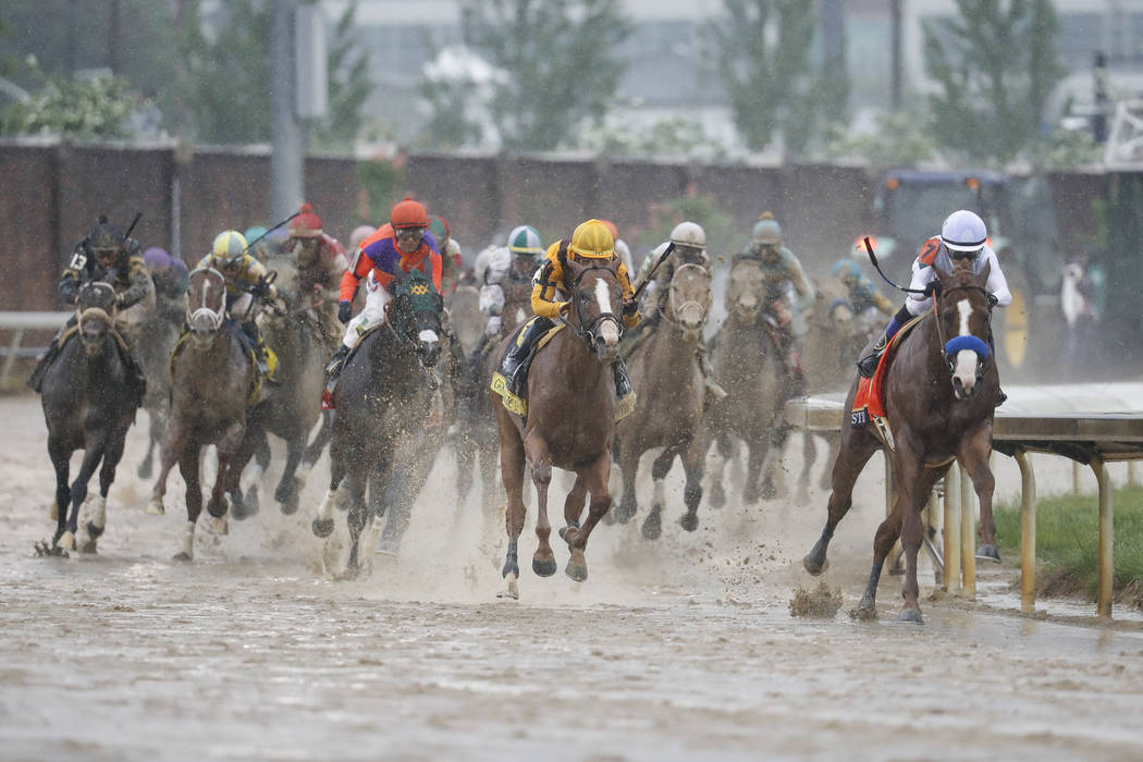 Mike Smith, right, rides Justify through the fourth turn and unto victory during the 144th running of the Kentucky Derby horse race at Churchill Downs Saturday, May 5, 2018, in Louisville, Ky. (AP ...