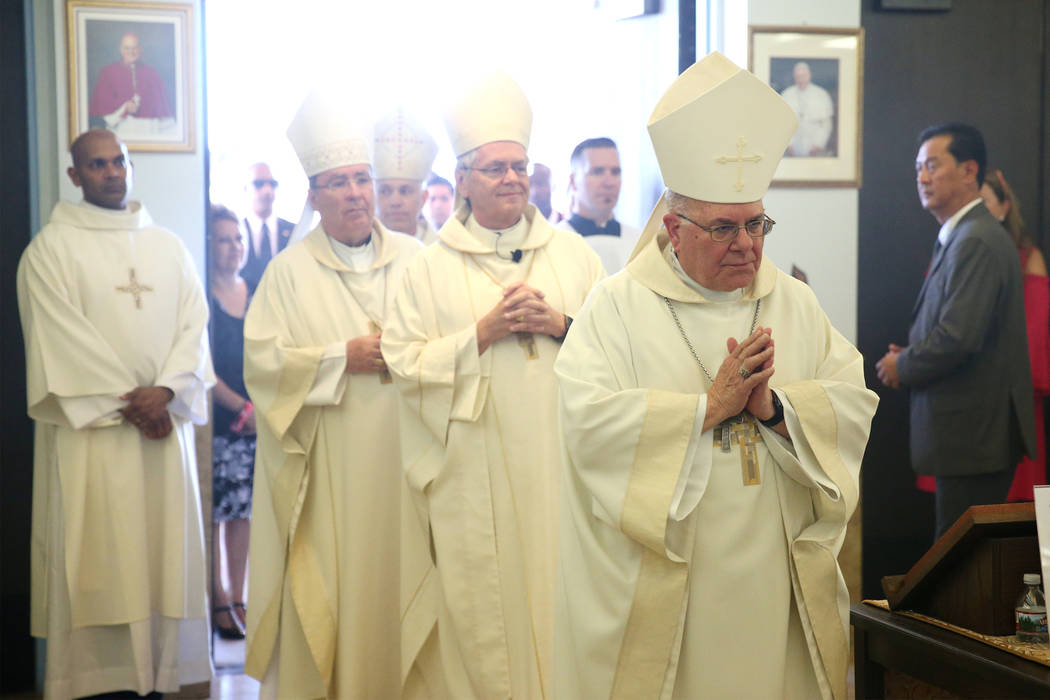 Retiring Bishop Joseph A. Pepe, right, followed by Rev. George Leo Thomas, during his installation as the third Bishop of Las Vegas, at The Shrine of the Most Holy Redeemer in Las Vegas, Tuesday, ...