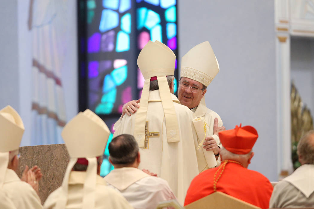 Retiring Bishop Joseph A. Pepe, right, embraces Bishop George Leo Thomas during his installation as the third Bishop of Las Vegas, at The Shrine of the Most Holy Redeemer in Las Vegas, Tuesday, Ma ...