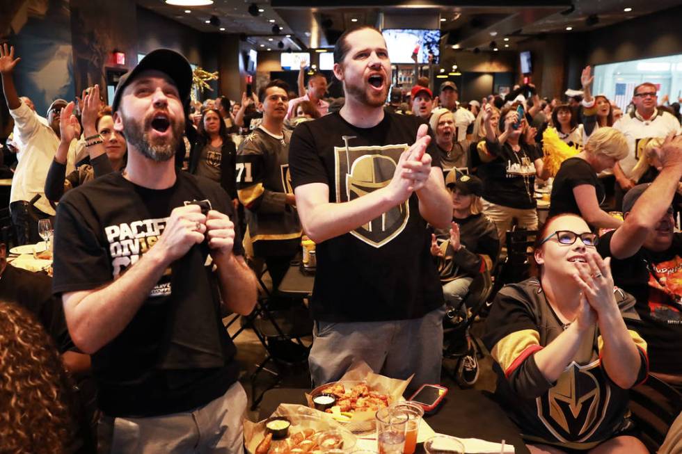 From left, Dustin Abell, Jackson Loless and Jennifer Anderson, all of Las Vegas, cheer after th ...