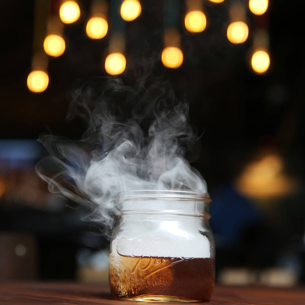 The Holy Smokes! cocktail, served with bourbon, maple, chocolate, and hickory smoke, at Eureka restaurant, 520 E. Fremont St., in Las Vegas, Wednesday, June 13, 2018. Erik Verduzco Las Vegas Revie ...