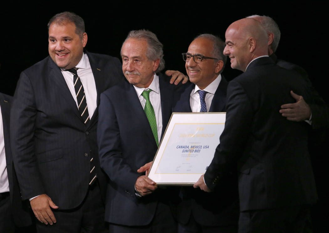 Delegates of Canada, Mexico and the United States celebrate with FIFA President Gianni Infantino, right, after winning a joint bid to host the 2026 World Cup at the FIFA congress in Moscow, Russia ...