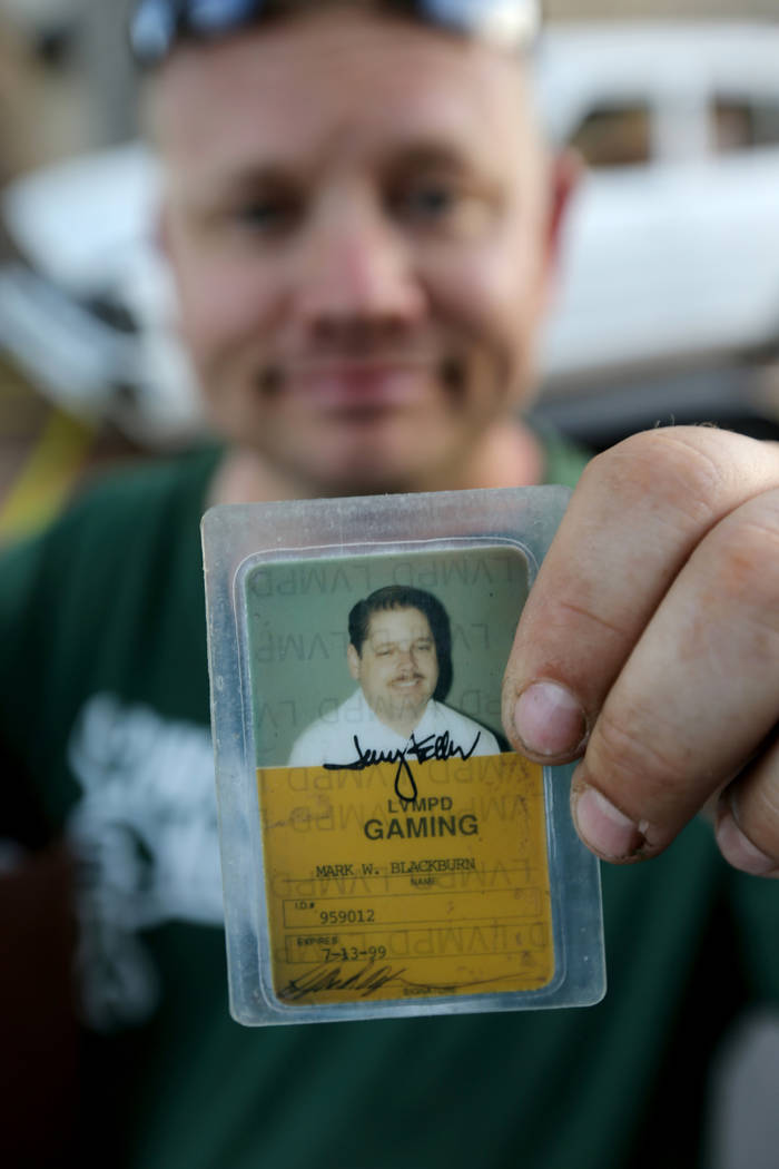 Michael Wiley Blackburn of Hartford, Wis. shows a work card that that belonged to his father, t ...