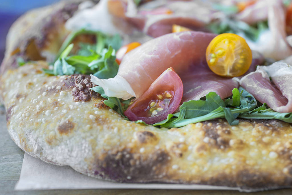 Vegas Meets Italy pizza with scamorza, mozzarella, ricotta, pistachio, dates, heirloom tomatoes, arugula, prosciutto and date cream at Pizzeria Monzú on Monday, July 2, 2018, in Las Vegas. Be ...