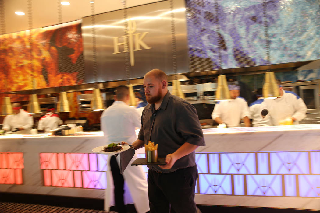 Food server Victor Gaitano delivers food to customers at Gordon Ramsay Hell's Kitchen in Las Vegas, Tuesday, July 17, 2018. Erik Verduzco Las Vegas Review-Journal @Erik_Verduzco