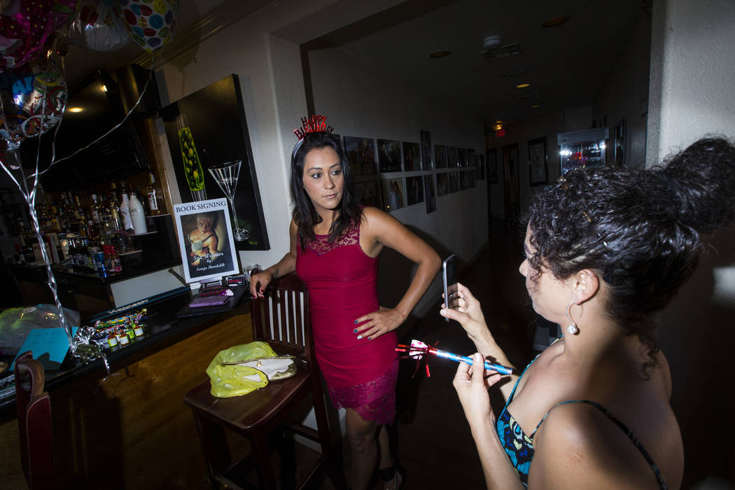 Prostitutes Cee Mia, left, and Dasha Dare talk before a birthday celebration at the Love Ranch ...