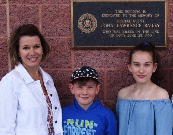 A photo of Special Agent John Bailey's daughter and grandchildren outside the FBI building in L ...