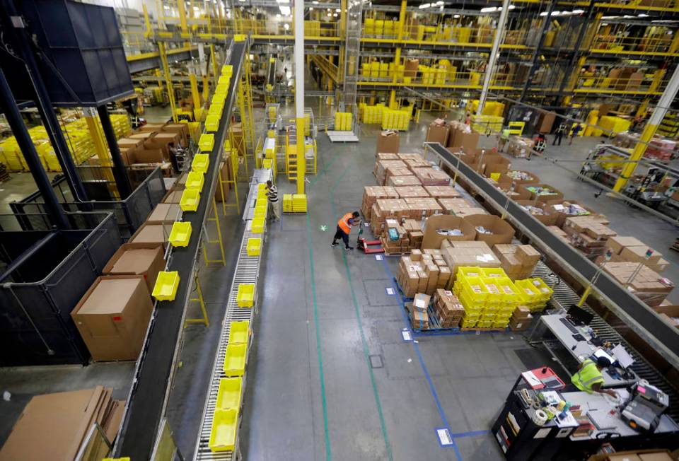 Employees work at the Amazon Fulfillment center in Robbinsville Township, N.J., Aug. 1, 2017. A ...