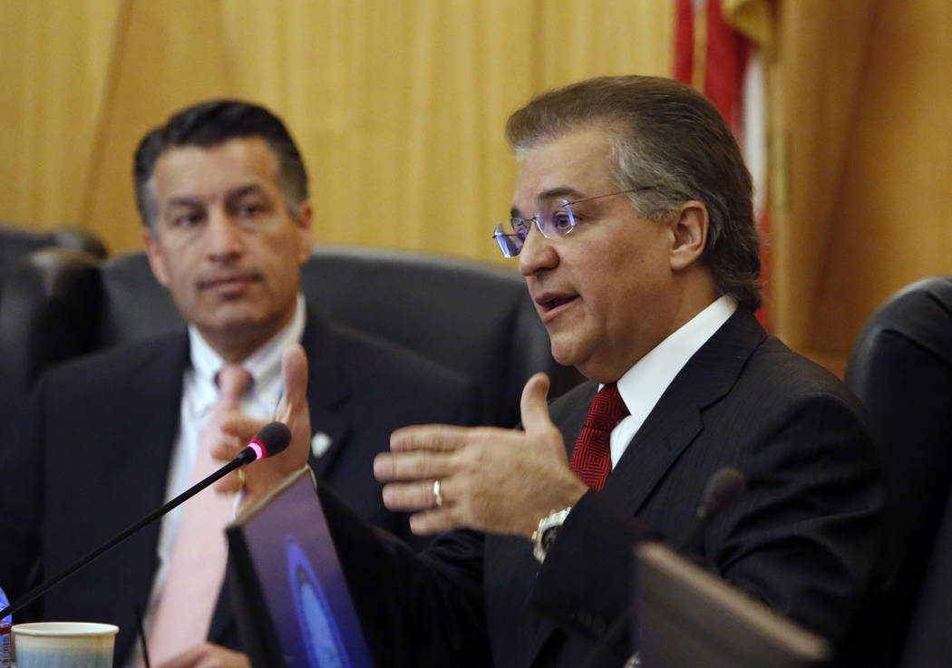 Gaming Commission Chairman, Tony Alamo, speaks as Gov. Brian Sandoval looks on during the Gaming Policy Committee, which meets at the direction of the governor, discusses marijuana policy involvin ...