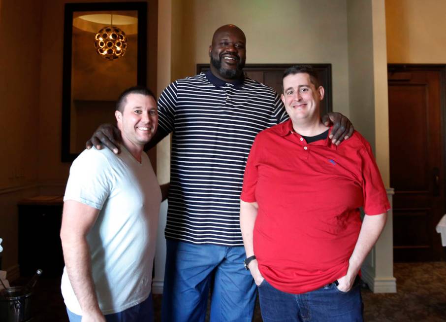 Former NBA player and owner of "Big Chicken" restaurant Shaquille O'Neil, center, pos ...