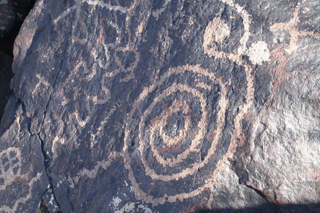 Petroglyphs were made by pecking on the natural desert varnish exposing the lighter color beneath. (Deborah Wall)