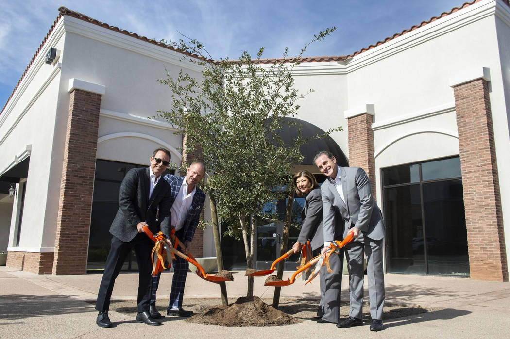 Mike Nigro, new owner, left, Michael Young, senior associate, Henderson Mayor Pro Tem Gerri Schroder and Mike Nigro, new owner, pose for a photograph outside of one of the newly purchased building ...
