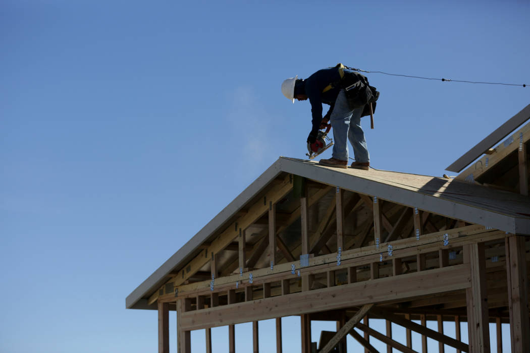 Construction worker finishes up the rooftop on a new home at Burson Ranch in Pahrump where developers have restarted a rural housing project. Thursday, November 15, 2018, . Michael Quine/Las Vegas ...