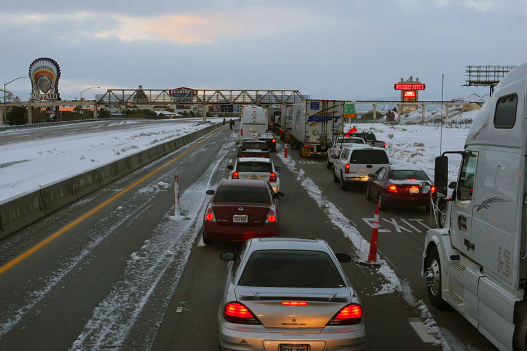 Vehicles line southbound Interstate 15 at Primm after the freeway was closed on Dec. 18, 2008, ...