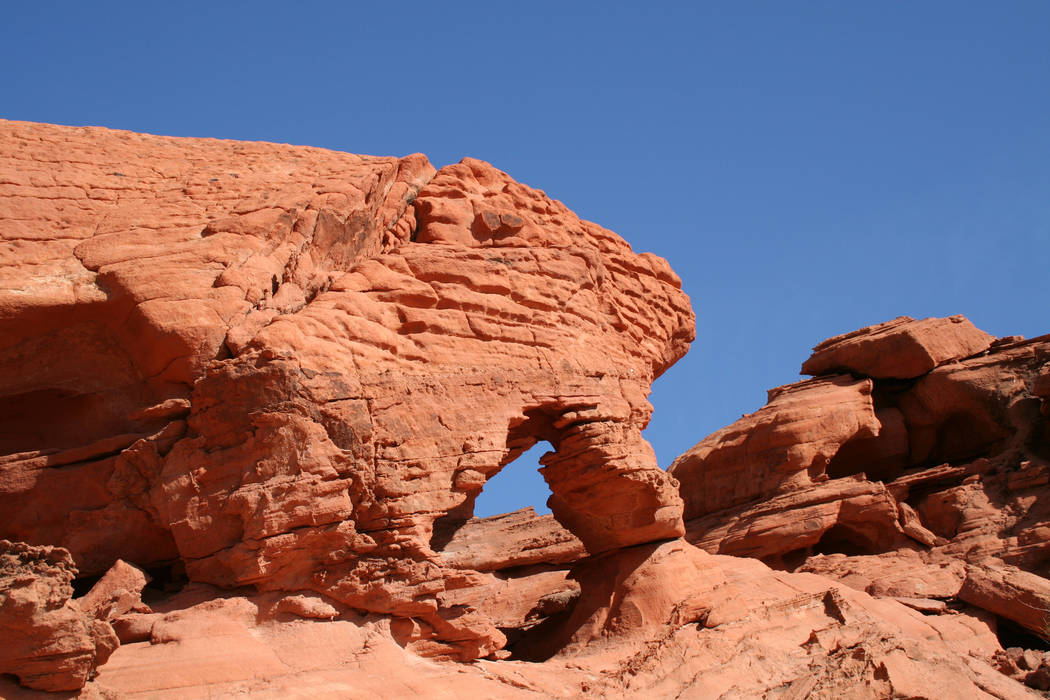 Over time, wind and blowing sand can create holes, windows, overhangs and arches in sandstone. ...