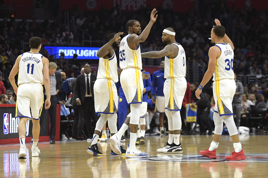 Golden State Warriors' Klay Thompson, Draymond Green, Kevin Durant, DeMarcus Cousins and Stephen Curry, from left, celebrate during the second half of the team's NBA basketball game against the Lo ...
