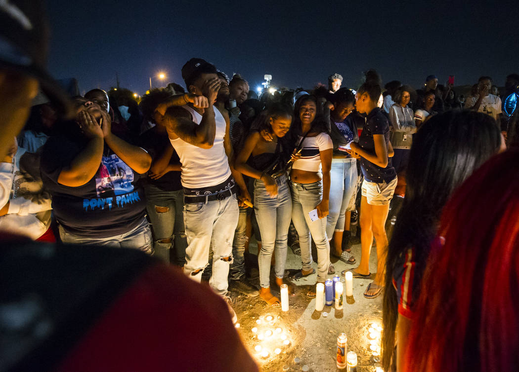 People mourn on Sept. 13, 2018, during a candlelight vigil in memory of Canyon Springs High Sch ...