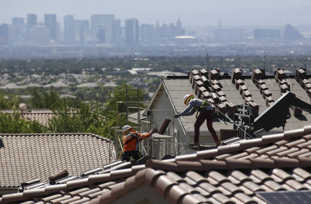 Construction workers set bundles of tile on the roof of an under-construction house in the master-planned community of Summerlin in Las Vegas on Saturday, June 30, 2018. Richard Brian Las Vegas Re ...