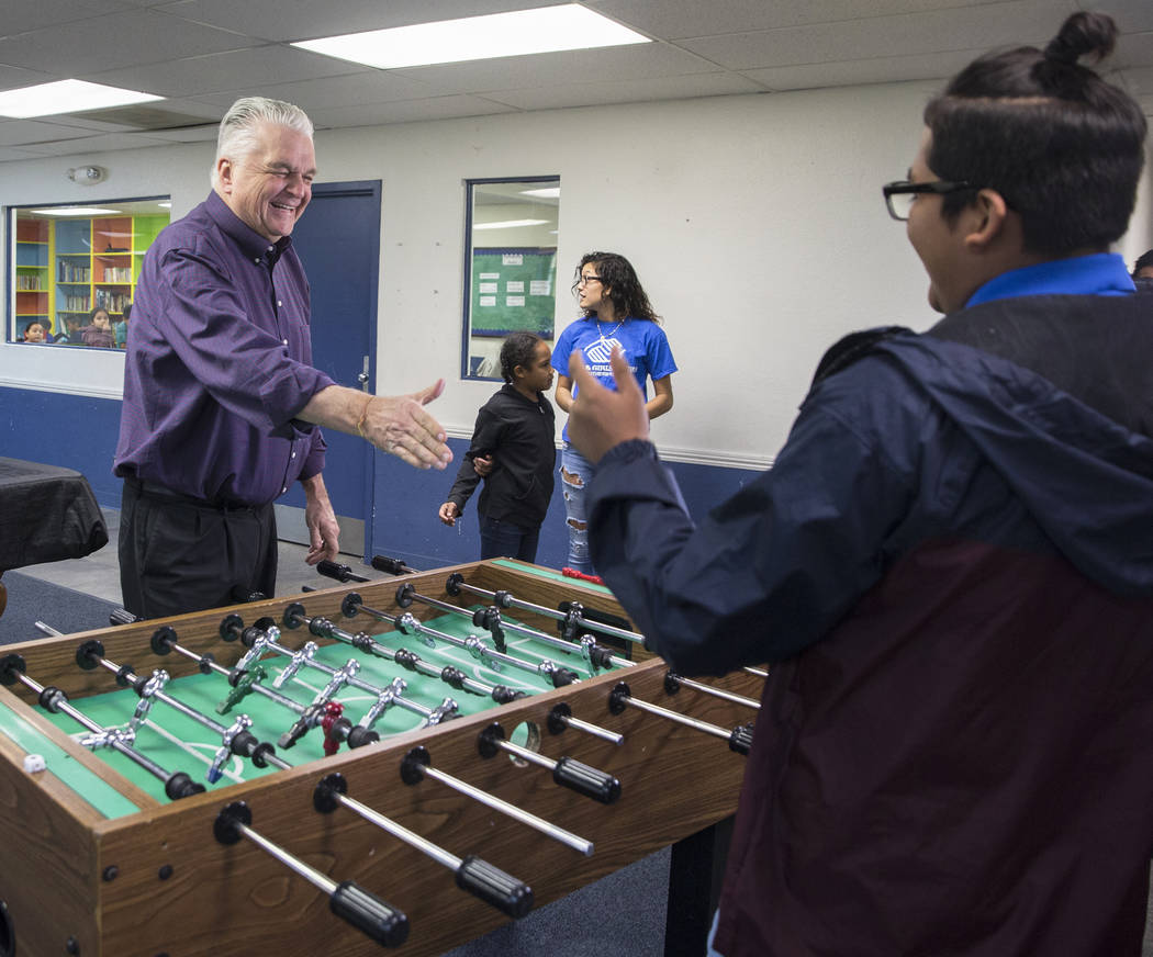 Governor-elect Steve Sisolak, left, shakes hands with Boys & Girls Clubs ambassador Jose De Dios after playing a game of foosball during a visit to the Boys & Girls Clubs of Southern Nevad ...